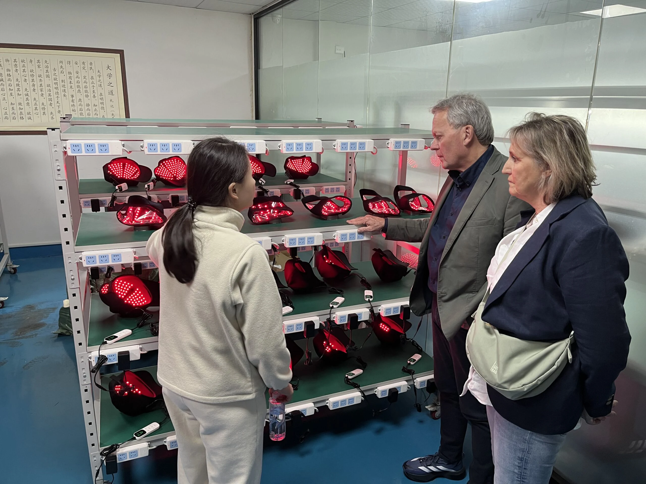 An in-person product discussion beside a display of light therapy caps.