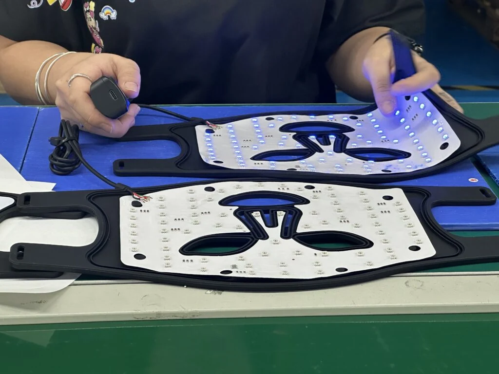 Operator handling illuminated mask components at a workbench